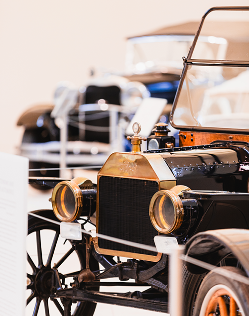 vintage cars on display in a museum