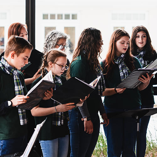 A group of teenagers singing in a choir