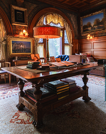 The interior of an ornate library in a historic home