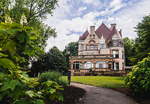 a historic mansion surrounded by lush green gardens
