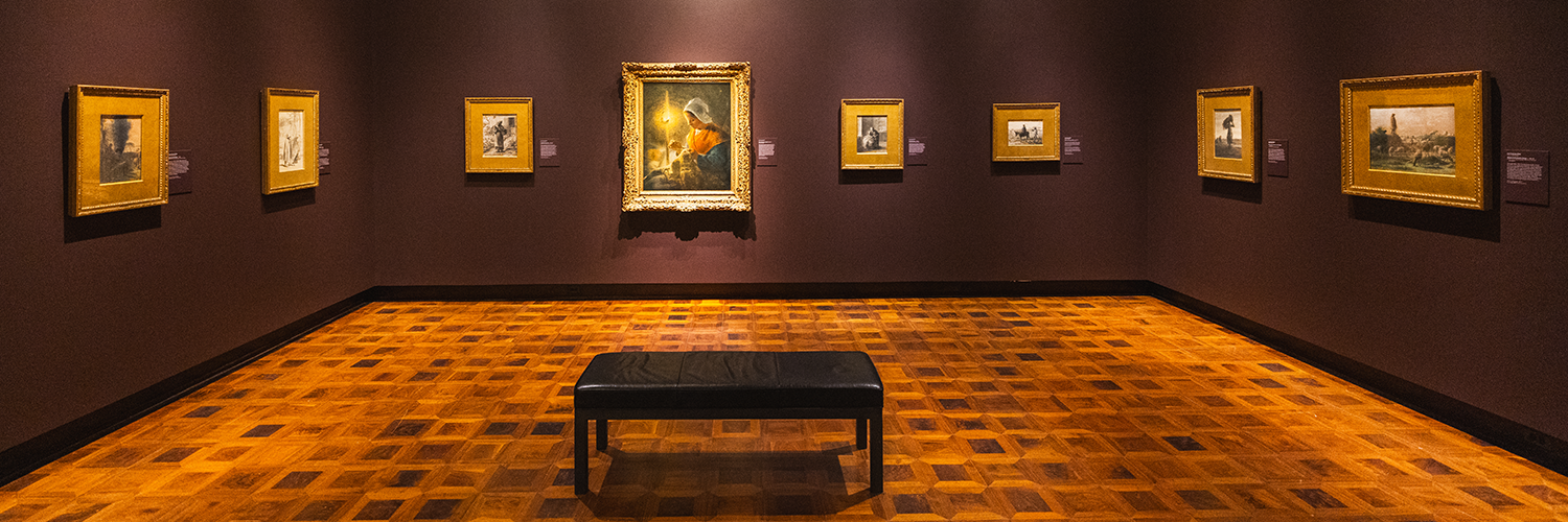 a collection of pastels and paintings hang on a maroon wall in a gallery